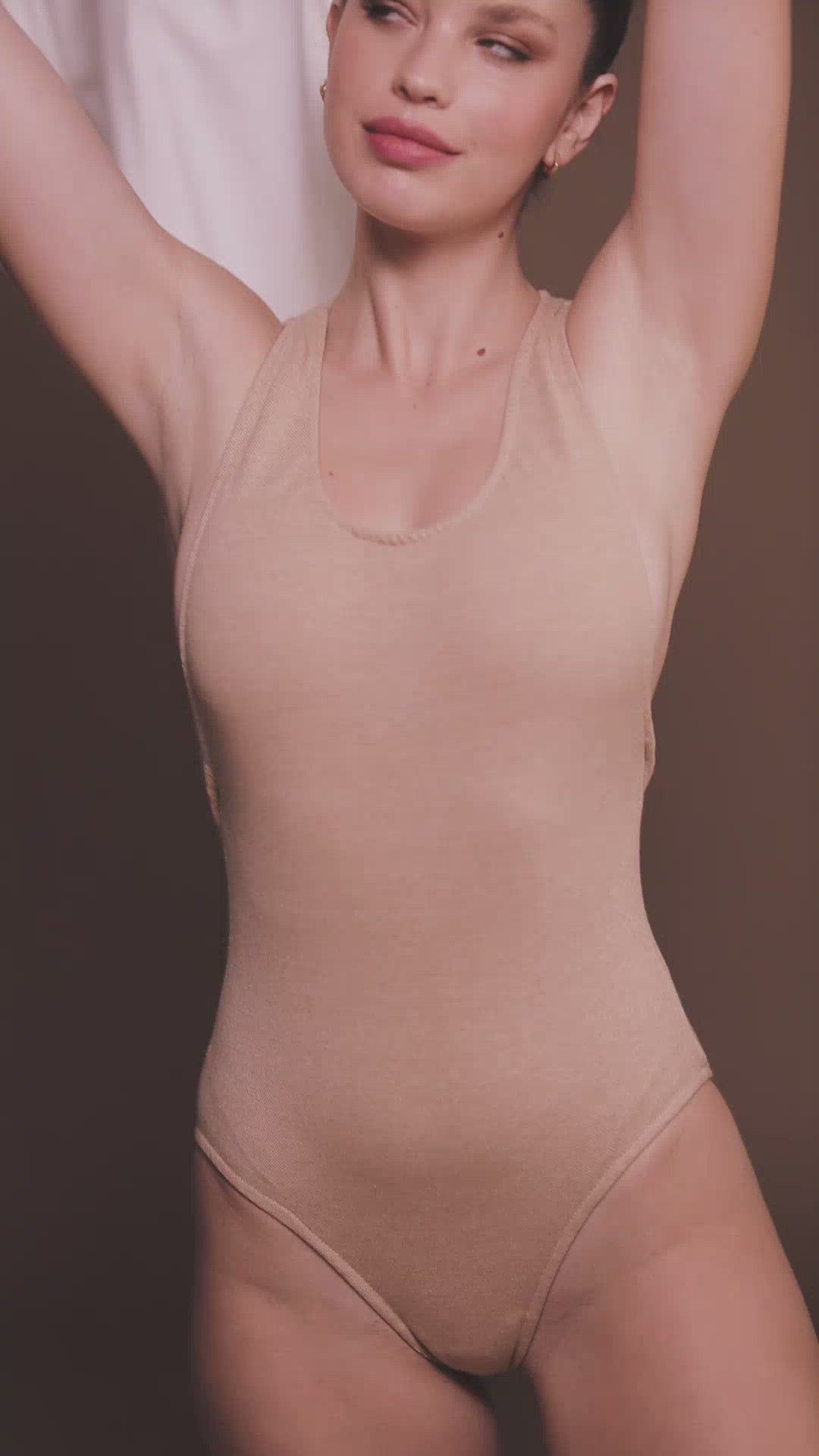 Video of: Sustainable Cross Back Bodysuit in Light Brown made by Organique.