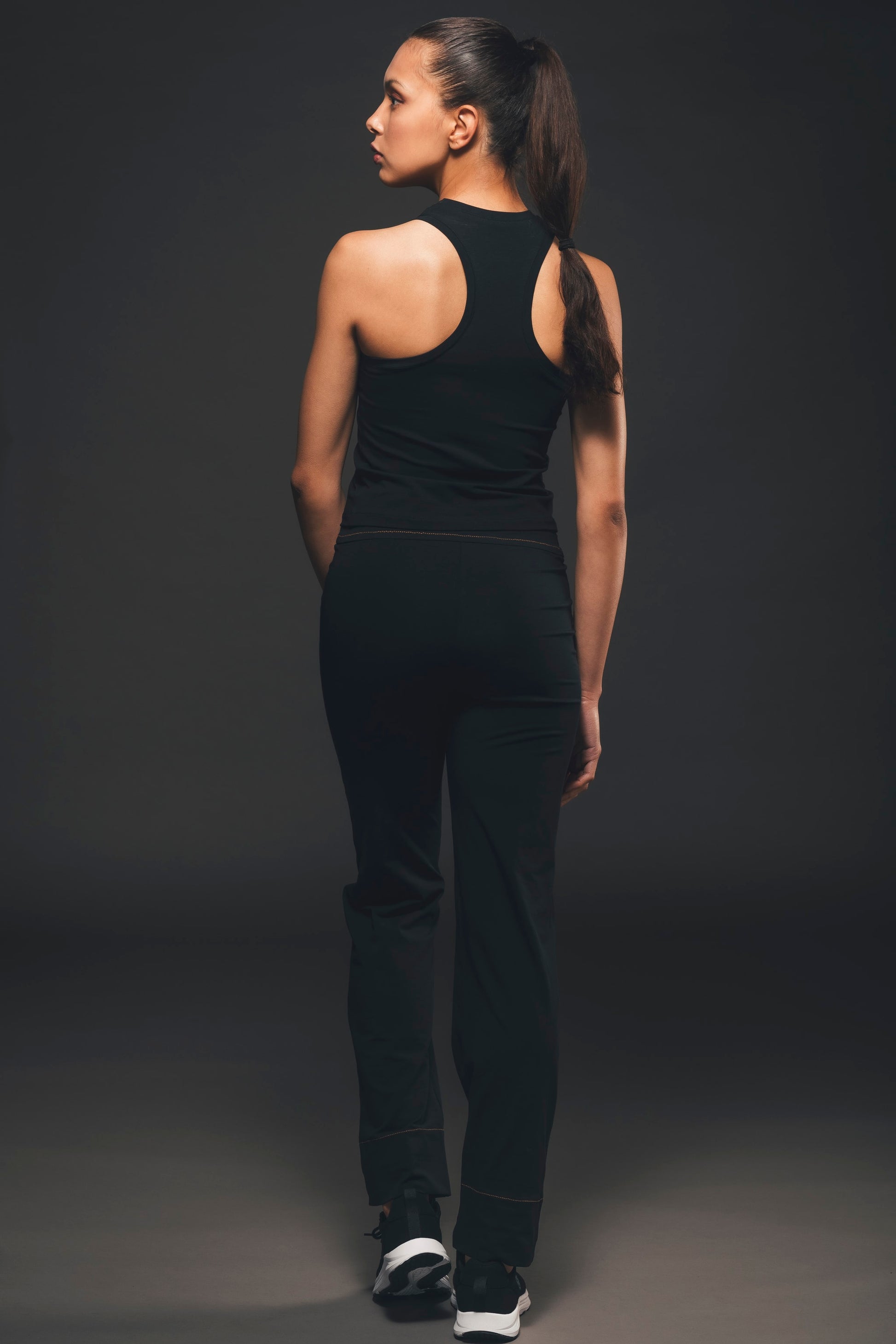 Image of back of black tank top made by Organique, a sustainable clothing brand.