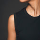 Image of neckline of black sleeveless jumpsuit made by Organique, a sustainable clothing brand.
