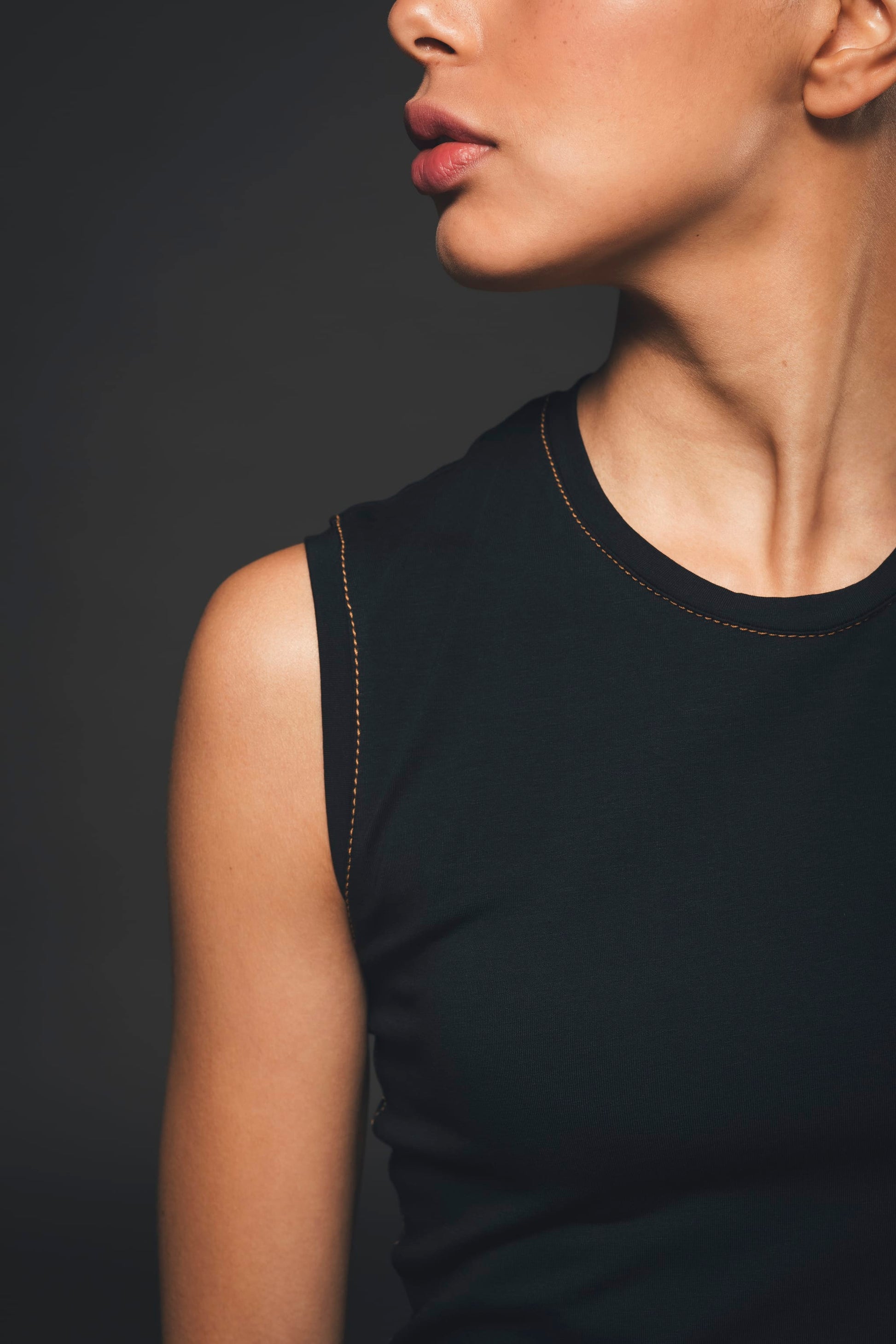 Image of neckline of black sleeveless jumpsuit made by Organique, a sustainable clothing brand.