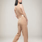 Image of light brown organic one shoulder jumpsuit made by Organique, a sustainable clothing brand.